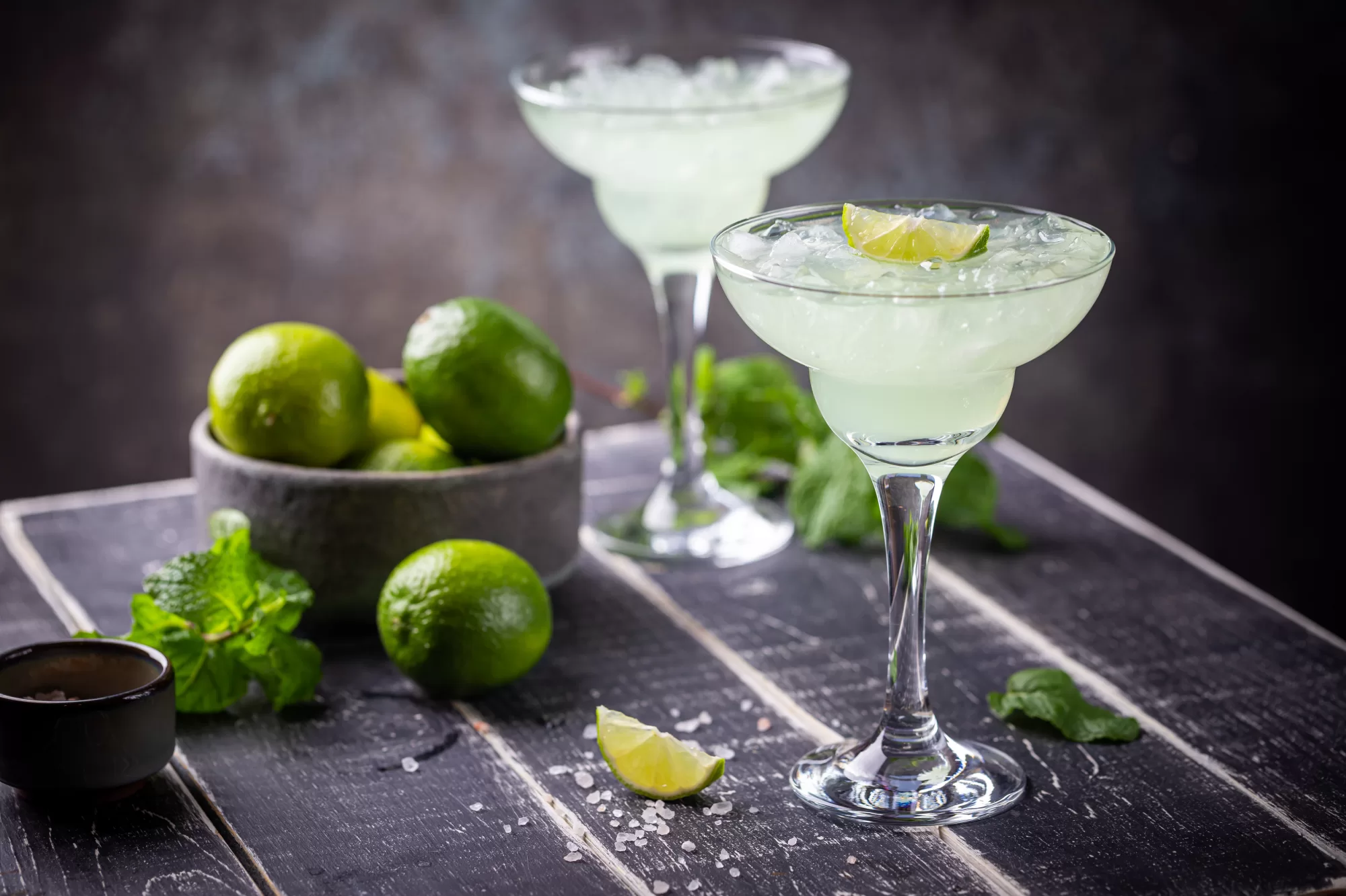 margarita cocktail with lime in a glass on dark background